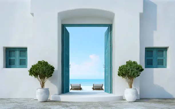 Photo of Santorini style gate open to the beach and sea view.3d rendering