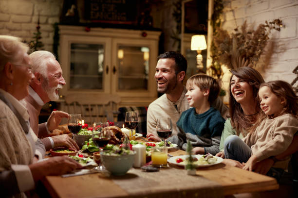 istock Happy multi-generation family enjoying in conversation during a meal at dining table. 1406658178