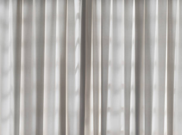 istock Light gray linen fabric curtain backlight on the curtain, background or banner idea, space for text 1406658254