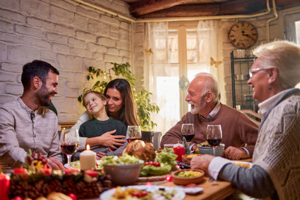 istock Happy multi-generation family enjoying in conversation during a meal at dining table. 1406658477