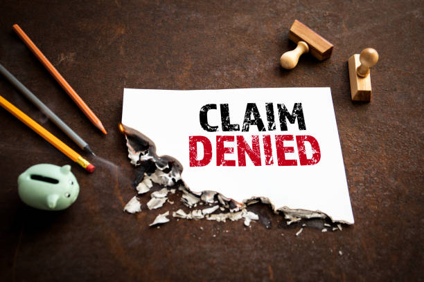 CLAIM DENIED. Text on a burning piece of paper CLAIM DENIED. Text on a burning piece of paper. recover tab stock pictures, royalty-free photos & images