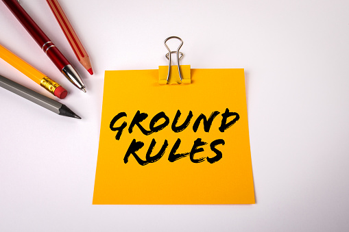 GROUND RULES. Office supplies on a white table.