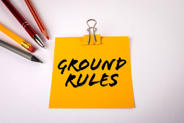 GROUND RULES. Office supplies on a white table stock photo