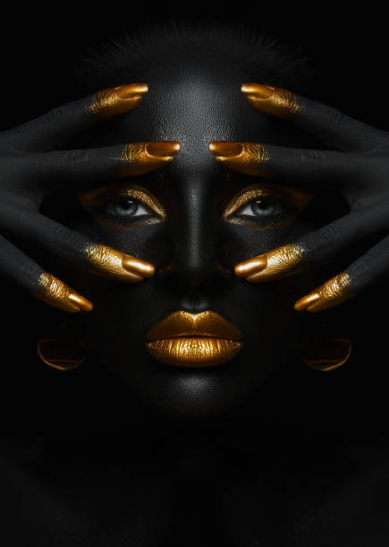 beauty woman black skin color body art, gold makeup lips eyelids, fingertips nails in gold color paint. professional gold makeup - stage makeup make up women body paint imagens e fotografias de stock