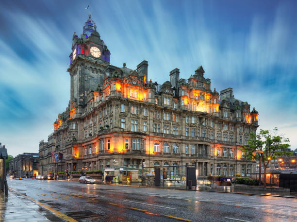Edinburgh at night scene with Lights on Princess street and Balmoral hotel on background stock photo