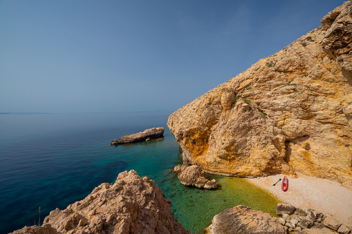 Cliffy coastline of croatian island with tiny beach
