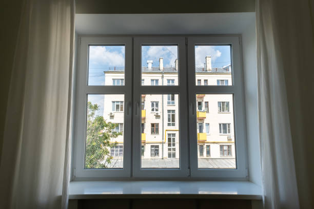 istock White window with curtains and city view. 1406668693
