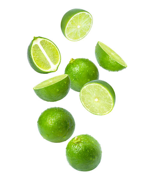 istock Lime with cut half sliced flying in the air isolated on white 1406670365