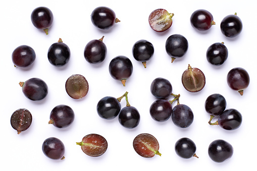 Black grape isolated on white background, top view, flat lay.