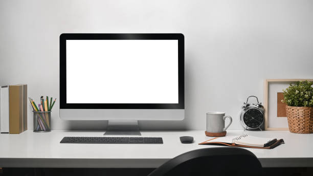 istock Contemporary workplace with computer pd, coffee cup, houseplant and stationery on white table. 1406671473