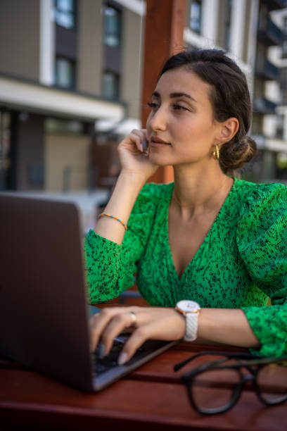 istock Caucasian woman working with laptop computer outside office. 1406671767