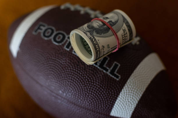 istock rugby ball and dollars, business 1406671815