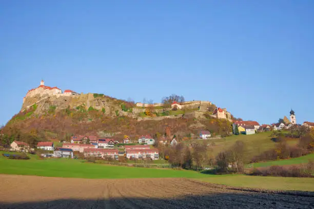 The medieval Riegersburg Castle on top of a dormant volcano, surrounded by charming little village and beautiful autumn landscape, famous tourist attraction in Styria region, Austria