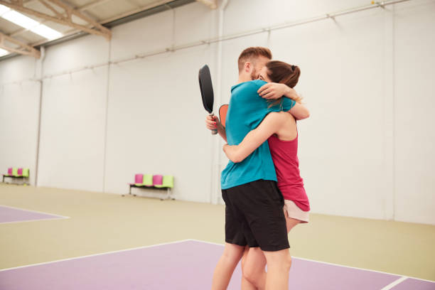 istock Two friends celebrate scoring a point in a pickleball match. 1406673510