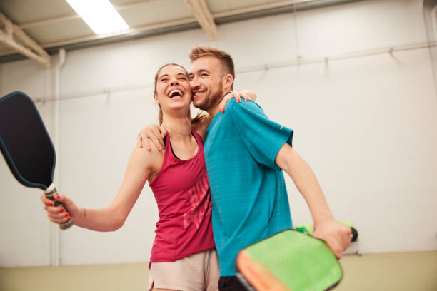 istock Two friends celebrate scoring a point in a pickleball match. 1406673517