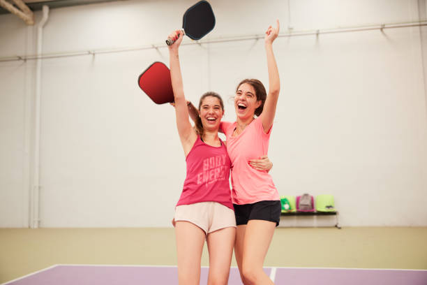 istock Two friends celebrate scoring a point in a pickleball match. 1406673534