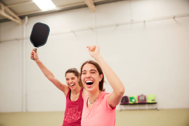 istock Two sisters celebrate scoring a point in a pickleball match. 1406673544