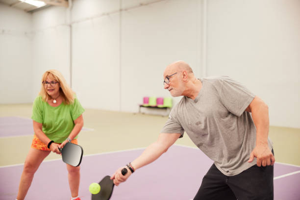Senior adults are playing Pickleball. stock photo