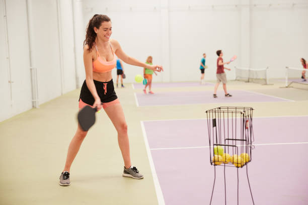 istock A pickleball player is serving on a court. 1406673871