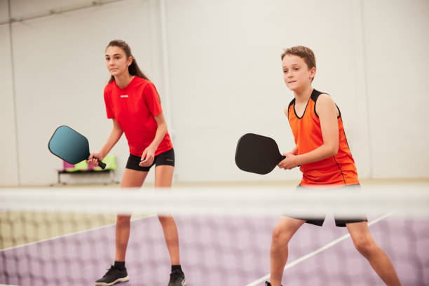 Teenagers are playing pickleball. stock photo