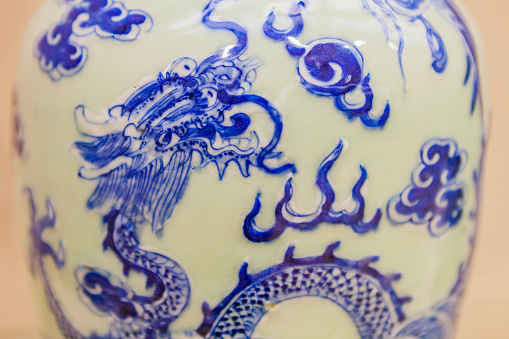 Close up of a dragon pattern on a porcelain jar, traditional style blue and white porcelain