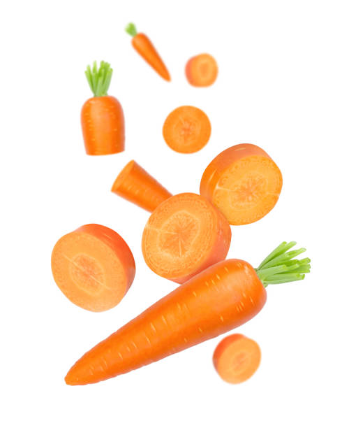 Carrot with cut sliced falling in the air isolated on white stock photo