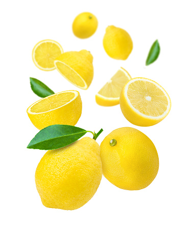 Lemon with leaf and cut half sliced flying in the air isolated on white background.
