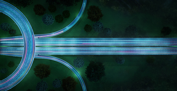 istock Aerial view of highway with car light trails at night 1406676558
