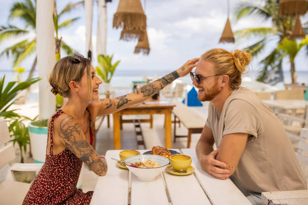 istock Young Caucasian couple enjoy breakfast at the beach restaurant 1406676809