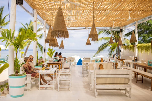 istock Young couple enjoy breakfast at the beach restaurant 1406678079