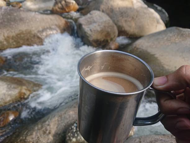 istock coffee in the metal cup with river background 1406678874
