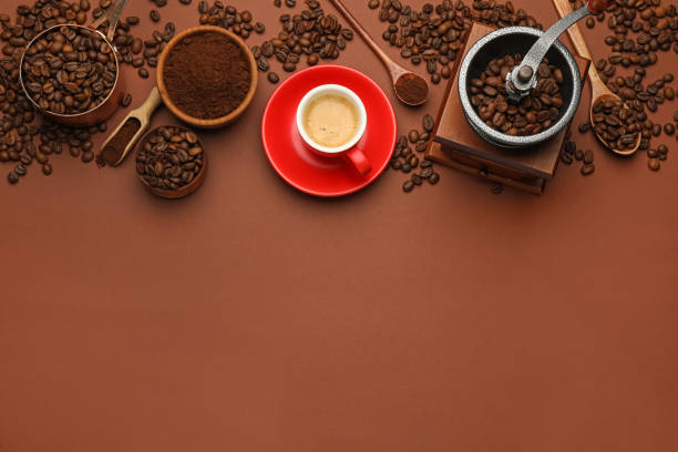 istock Flat lay composition with coffee grounds and roasted beans on brown background, space for text 1406679286