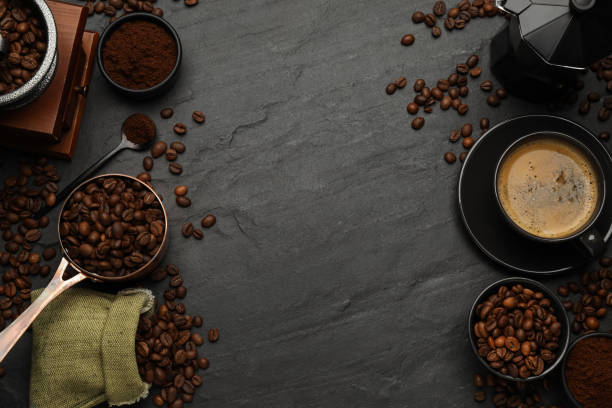 istock Flat lay composition with coffee grounds and roasted beans on black background, space for text 1406679287
