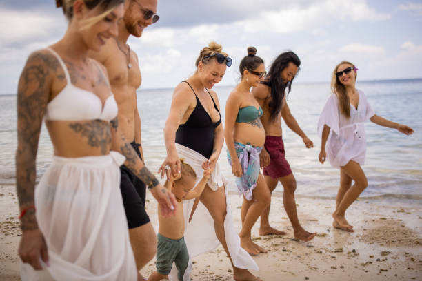 group of multiracial friends walking on the beach - tattoo father family son imagens e fotografias de stock