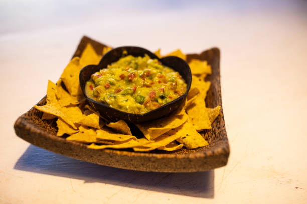 Nachos and guacamole on the plate at the restaurant