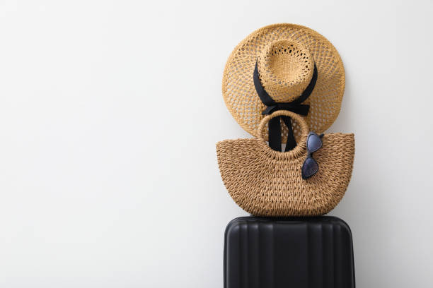 istock Suitcase and summer accessories on light background. Space for text 1406681014