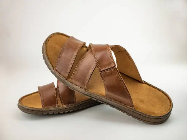 Photo of Male brown leather sandals. Close up on the white background.