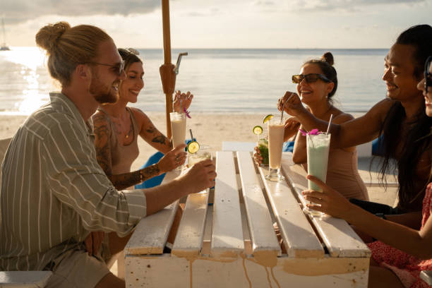istock Multiracial friends drinking coctails at the beach bar 1406684835
