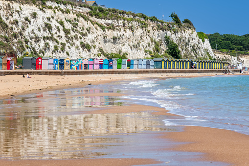 Beach huts and the sandy beach at Stone Bay in the seaside town of Broadstairs, east Kent, England