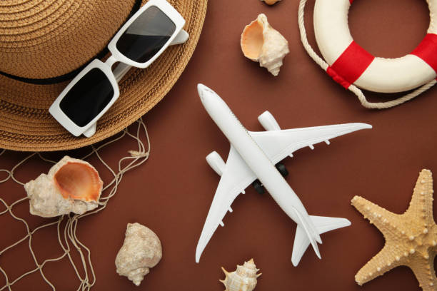 istock Travel, vacation concept. Hat with sunglasses and sea shells on brown background. Space for text. Vertical photo 1406688370
