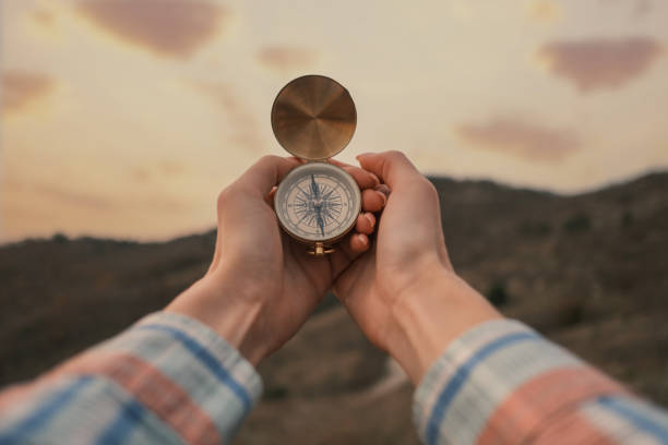 istock Vintage compass in female hands in the mountains. 1406689276