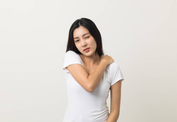 istock Asian woman has problem with structural posture She had neck and shoulder pain. She massaged her neck and shoulders for relief. reduce muscle tension. Standing on isolated white background 1406691803