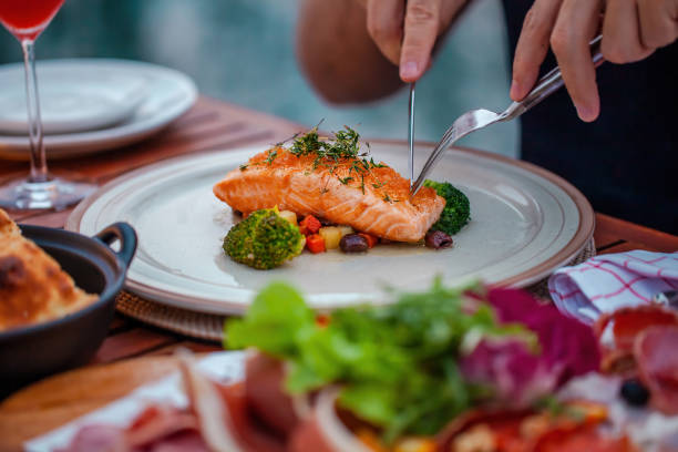 istock Man on luxury dinner served on table with fresh seafood in luxury restaurant 1406692030