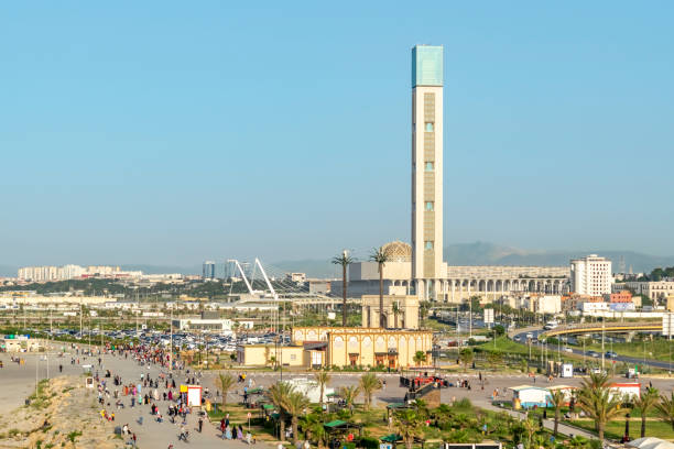 The geat mosque of algiers and Sablettes public park The Great Mosque of Algiers, world's tallest minaret and it's dome seen from Sablettes promenade's ferry wheel. Aerial view of a crowd people walking, blue clear sky and mountains in background. algiers stock pictures, royalty-free photos & images