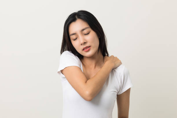 istock Asian woman has problem with structural posture She had neck and shoulder pain. She massaged her neck and shoulders for relief. reduce muscle tension. Standing on isolated white background 1406692545