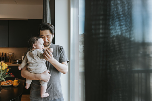 Japanese father and baby daughter spending time together at home
