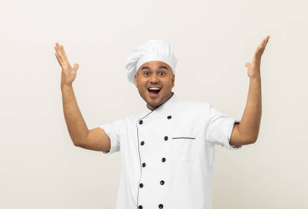 istock Happy Smiling Young handsome asian man chef in uniform arms stretch feeling successful excited on isolated background. Cooking indian man Occupation chef or baker in kitchen restaurant and hotel. 1406693090