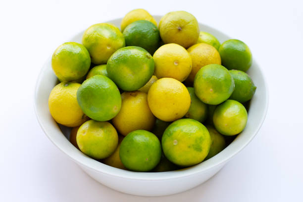 istock Frsh limes in bowl on white background. 1406694447