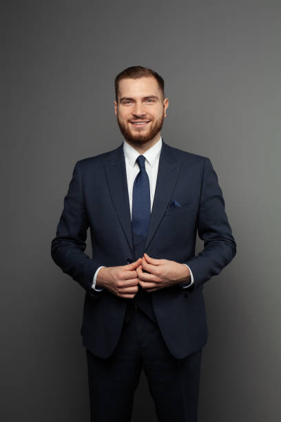 istock Attractive young businessman wearing suit on grey background 1406697323