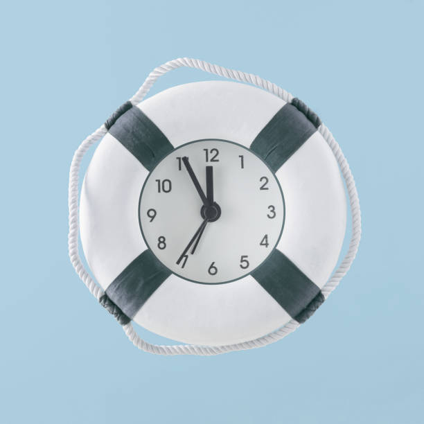 istock Minimal creative abstract summer vacation scene made of lifebelt with clock on isolated pastel blue background. Time for save the lifes. Concept of stop the war. Nautical or holiday beach party idea. 1406697777